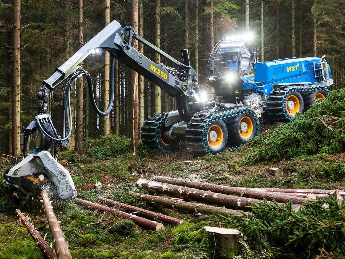A blue tracked forestry harvester from Rottne